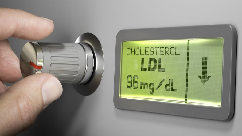 Cholesterol monitor showing LDL value and downward arrow