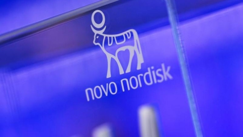 Novo Nordisk logo displayed on illuminated blue corporate wall